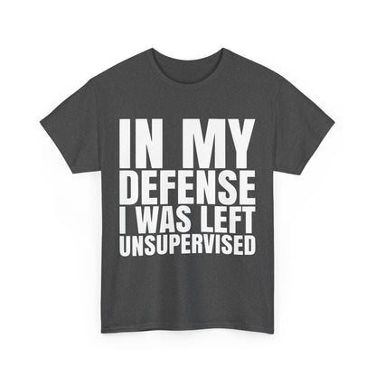 Front view of the 'In My Defense Graphic Tee Shirt', featuring bold typography that reads 'IN MY DEFENSE I WAS LEFT UNSUPERVISED' in white against a chic dark grey background.