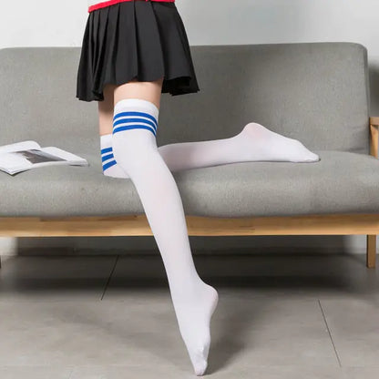 Elegant women's black and white solid color long socks stockings featuring blue stripes, styled with a skirt, perfect for chic casual outfits.