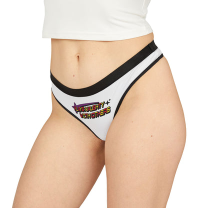 Elegant model showcasing a stylish white thong featuring 'Plays Naughty With Others' in vibrant lettering, paired with a chic crop top, epitomising bold femininity.