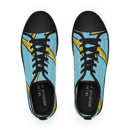 Stylish angle view of Volt Manchester Men’s Lowtop Sneakers from Dazzling Dreams Studio, featuring dynamic yellow lightning bolt graphics on a contemporary blue canvas backdrop.