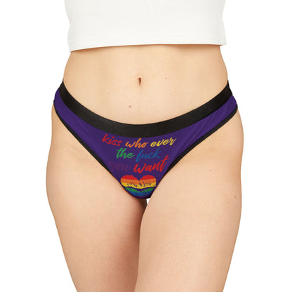 Luxury women's thong featuring a vibrant purple background with a playful slogan 'Kiss whoever the fuck you want' in multicoloured lettering, adorned with a rainbow heart design, ideal for celebrating love and self-expression.
