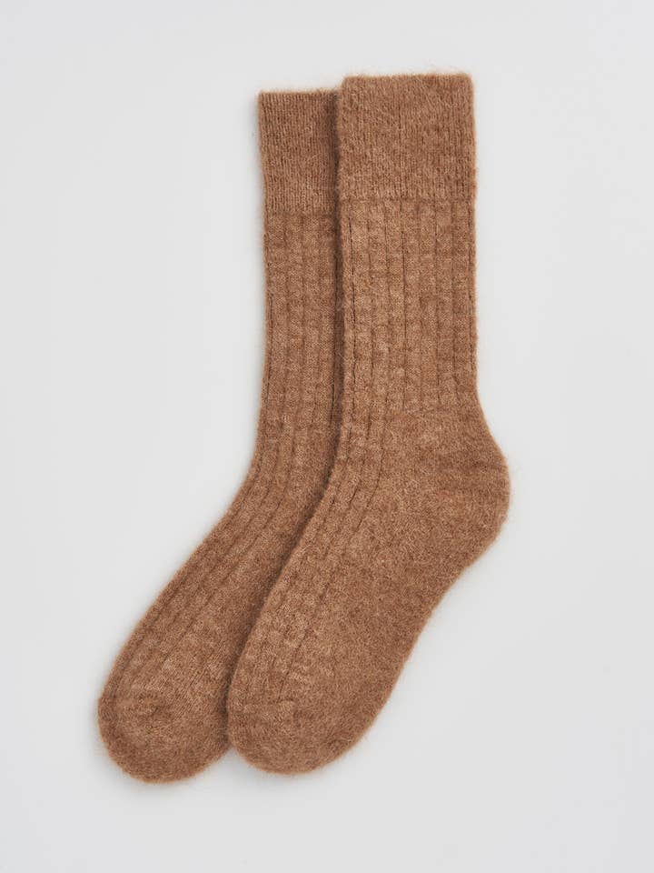 Chic presentation of ultra-soft bed socks made from alpaca wool, ideal for cosy nights and luxury gifting.