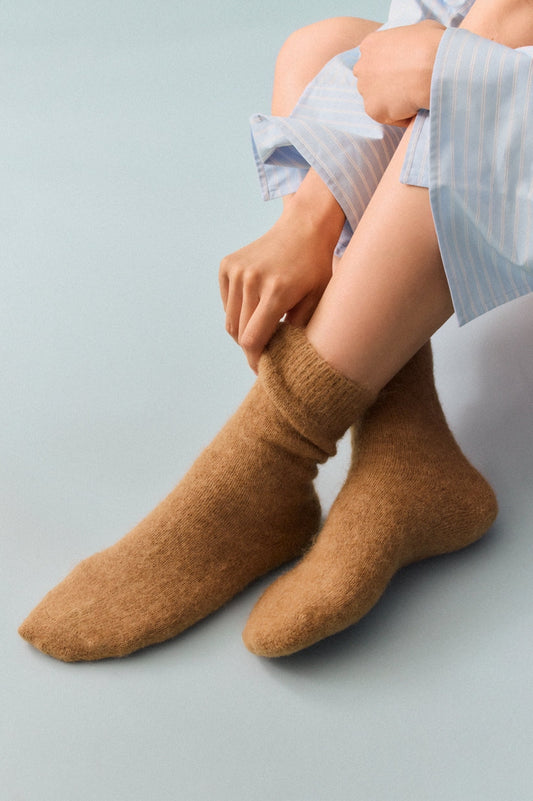 Close-up of the luxurious alpaca bed socks, highlighting their soft texture and rich fabric composition for superior comfort.