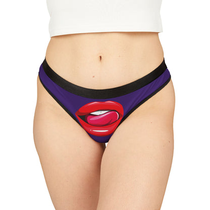 Stylish women's thong featuring a playful graphic of red lips with a pink tongue on a purple background, perfect for cheeky gifting.