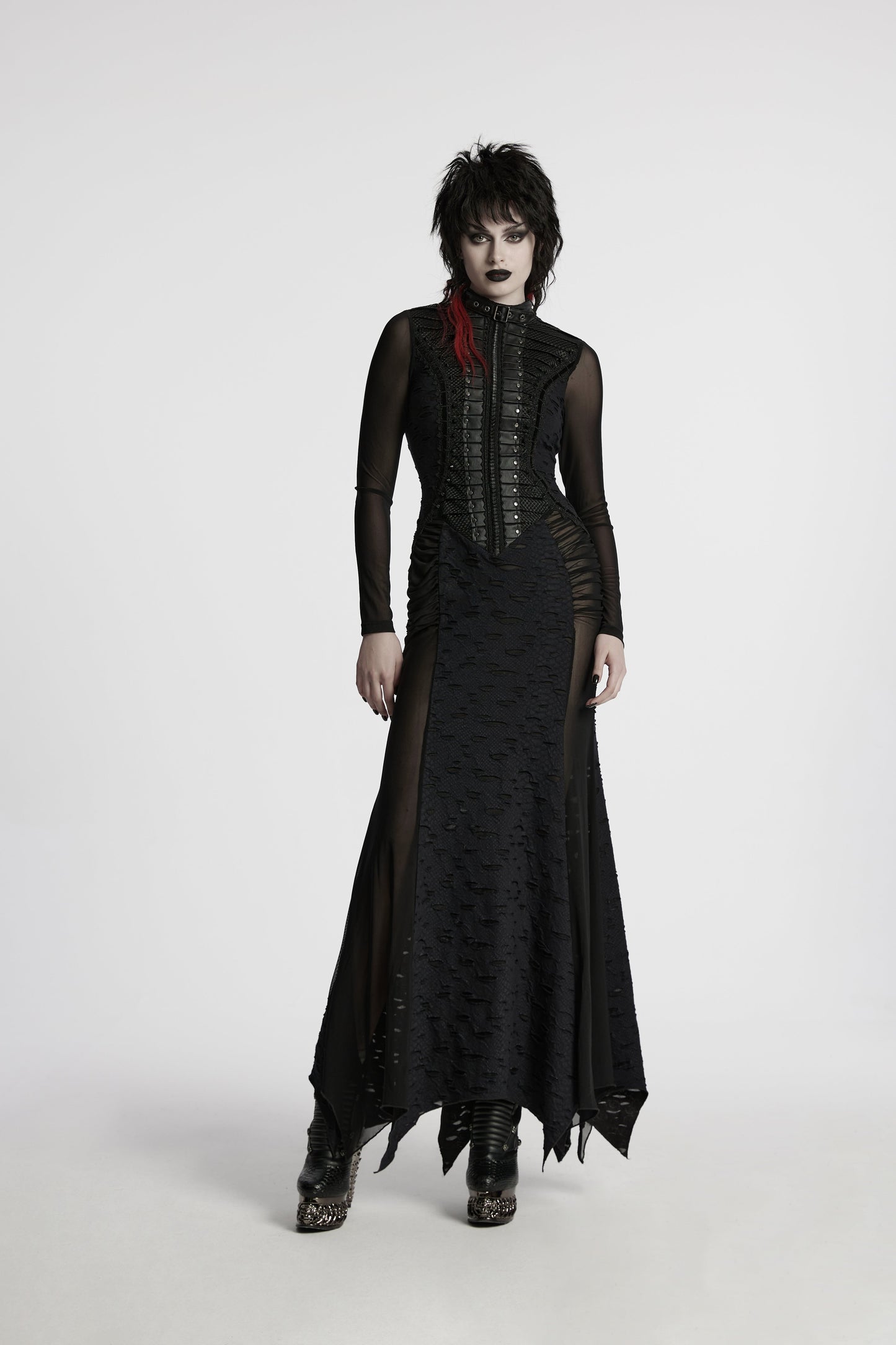 Delicate lace and spike embellishments at the waist of the black maxi dress, enhancing its alternative fashion appeal.