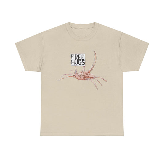 Luxurious Alien Xenomorph Facehugger Free Hugs Graphic Unisex Tee Shirt in beige, featuring a whimsical facehugger design with a playful 'Free Hugs' sign.