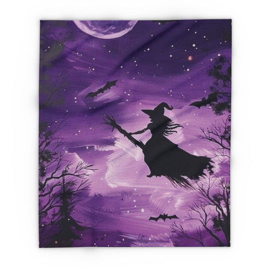 Decorative and Warm Halloween Spooky Arctic Fleece Blanket depicting a magical scene with a witch on her broomstick, set against a rich purple background filled with stars and bats.