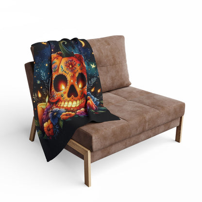 Chic presentation of the Decorative and Warm Halloween Spooky Arctic Fleece Blanket draped over a contemporary couch, highlighting its enchanting skull pumpkin design for a luxurious Halloween ambiance.