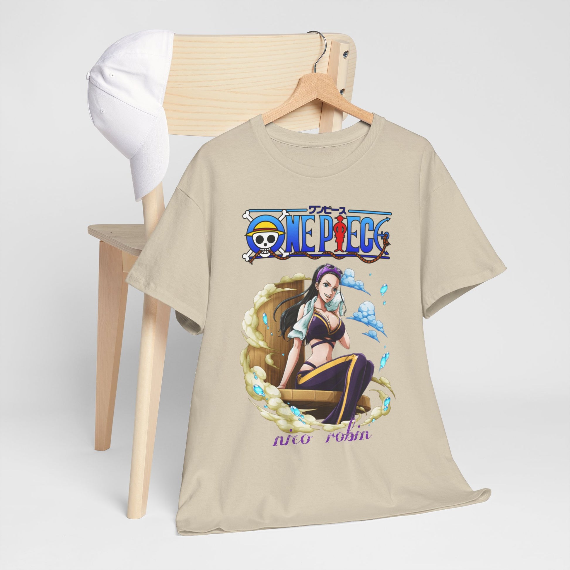 Stylish beige One Piece t-shirt with a captivating illustration of Nico Robin displayed on a wooden chair alongside a fashionable cap, embodying casual elegance.