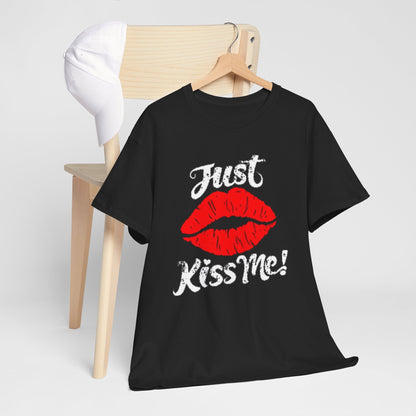 Artfully arranged black cotton t-shirt hanging on a wooden chair, featuring an eye-catching graphic with red lips and 'Just Kiss Me!' text, ideal for contemporary fashion lovers.