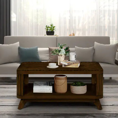 Walnut coffee table elegantly styled with decorative items, including a plant and books, in a sophisticated living room setting that exudes luxury.