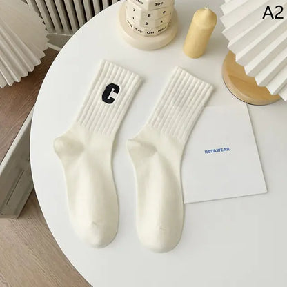 Elegant and comfortable white socks with a black letter detail, part of the luxurious Women's Tie-Dye Middle Tube Socks collection.