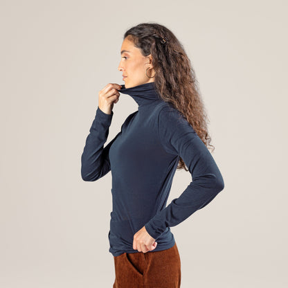 Model wearing a luxury organic cotton long-sleeved turtleneck t-shirt, illustrating versatility and chic styling in fashion.