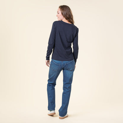 Woman model elegantly wearing the Luxury Organic Cotton Long Sleeve V-Neck Top, emphasizing the stylish fit and sustainable materials of this contemporary vegan apparel.