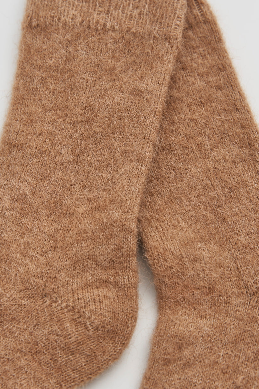 Luxurious ultra soft alpaca bed socks displayed elegantly, showcasing their cozy texture and warm comfort for ultimate relaxation.