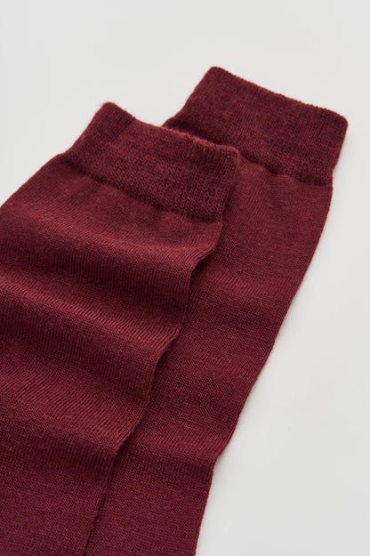 Luxurious Merino wool calf-length socks displayed elegantly in a soft fabric texture, odour-resistant and perfect for everyday wear.