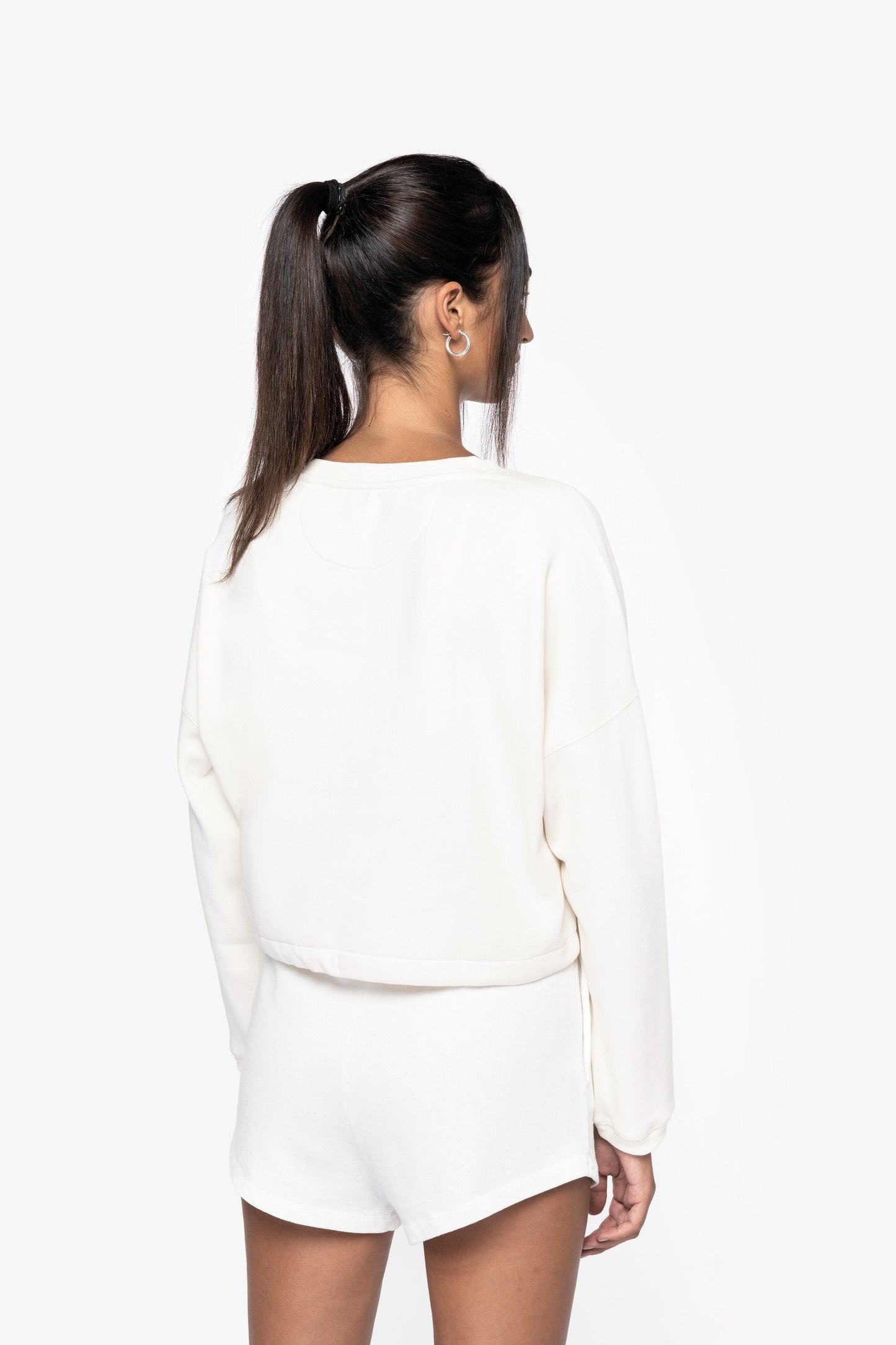 Close-up of the sustainable fabric of the oversized cropped sweatshirt, featuring 65% organic combed cotton and 35% recycled polyester for eco-friendly fashion.