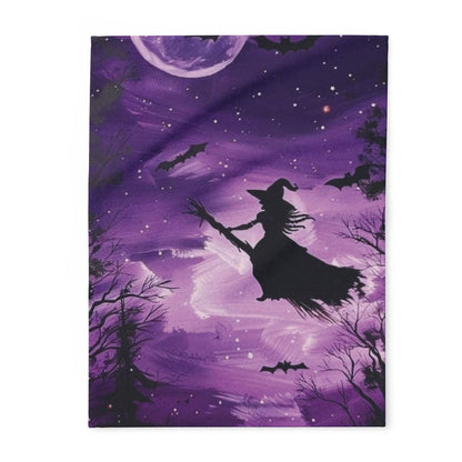 Decorative and Warm Halloween Spooky Arctic Fleece Blanket featuring a whimsical silhouette of a witch flying against a purple night sky adorned with bats and a full moon.