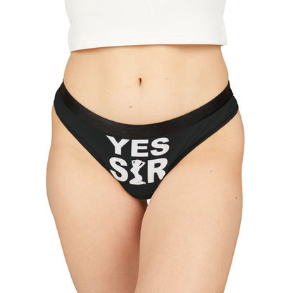 Luxury women's thong featuring bold 'YES SIR' graphic on a sleek black background, exemplifying playful elegance.