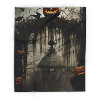Decorative and Warm Halloween Spooky Arctic Fleece Blanket featuring a haunting scene with jack-o'-lanterns, dark trees, and a mysterious old house, perfect for adding a festive touch to your Halloween decor.