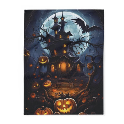 Decorative and Warm Halloween Spooky Arctic Fleece Blanket featuring a haunted house illuminated by a full moon, surrounded by glowing jack-o'-lanterns, perfect for adding an elegant touch to your Halloween decor.