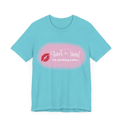 Sabrina Carpenter Inspired Unisex Short Sleeve Tee displaying a playful front design with the text 'Short ‘n’ Sweet, I'm Working Late...', complemented by lipstick print.