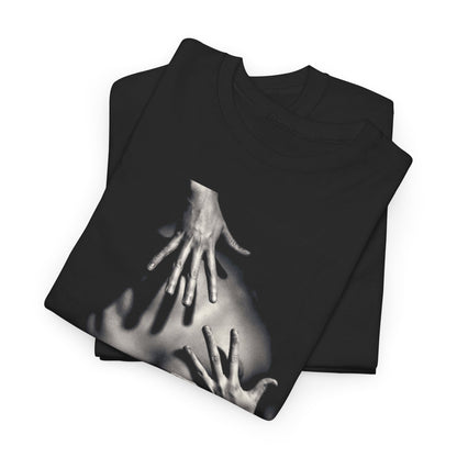 Premium black t-shirt folded neatly, adorned with an eye-catching graphic of hands on a nude silhouette, embodying a blend of artistry and elegance.