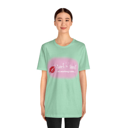 Sabrina Carpenter Inspired Unisex Short Sleeve Tee with Vibrant Lipstick Print, elegantly styled on a female model in pastel green, emphasising the chic design and comfort.