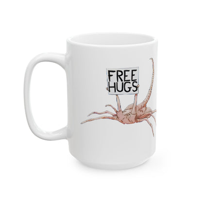 The Alien Xenomorph Facehugger Free Hugs Funny Ceramic Mug being held in hand, demonstrating its ergonomic design and cheeky appeal for those who love a good laugh.