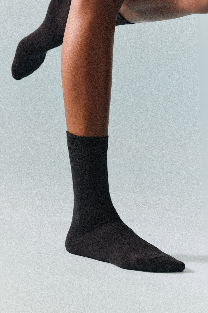 Close-up shot of Merino wool calf-length socks showcasing the rich craftsmanship and smooth finish, ideal for temperature regulation.