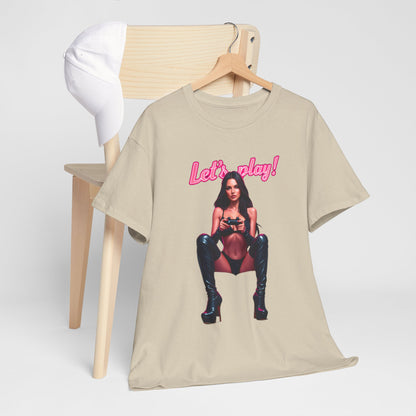 Sophisticated unisex t-shirt draped on a chair, featuring a bold 'Let's play!' design, accompanied by a stylish cap, appealing to fashionable gamers.