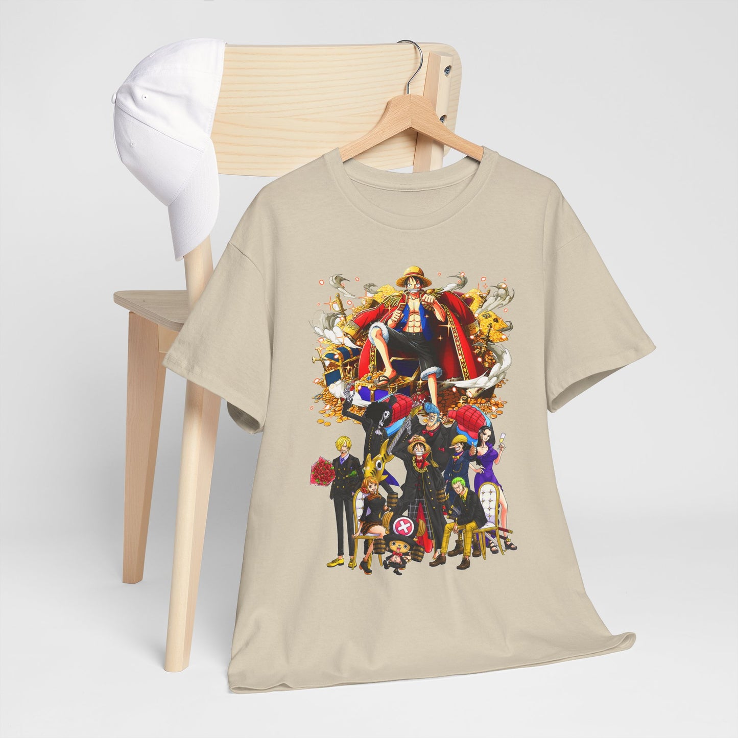 Stylish beige t-shirt elegantly displayed on a hanger, featuring a detailed graphic of anime characters amidst a treasure setting, reflecting a blend of creativity and fashion.