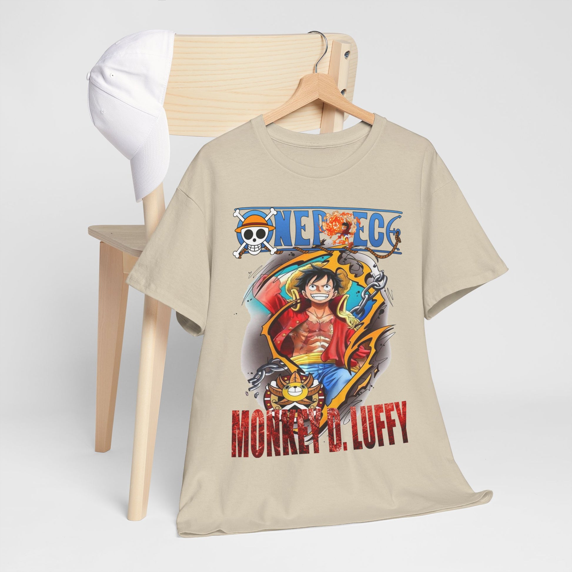 Stylishly arranged Monkey D. Luffy T-Shirt alongside a white cap, highlighting its adventurous spirit and trendy design.