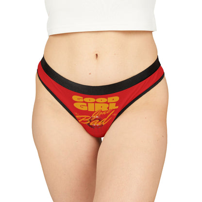 Elegant model showcasing the 'Good Girl Gone Bad' thong panties with a luxurious red and black design and bold graphic lettering.
