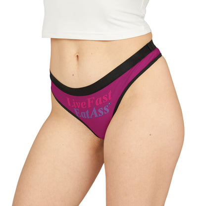 Luxury purple thong panties featuring the cheeky slogan 'Live Fast, Eat Ass', designed for bold confidence and playful elegance.