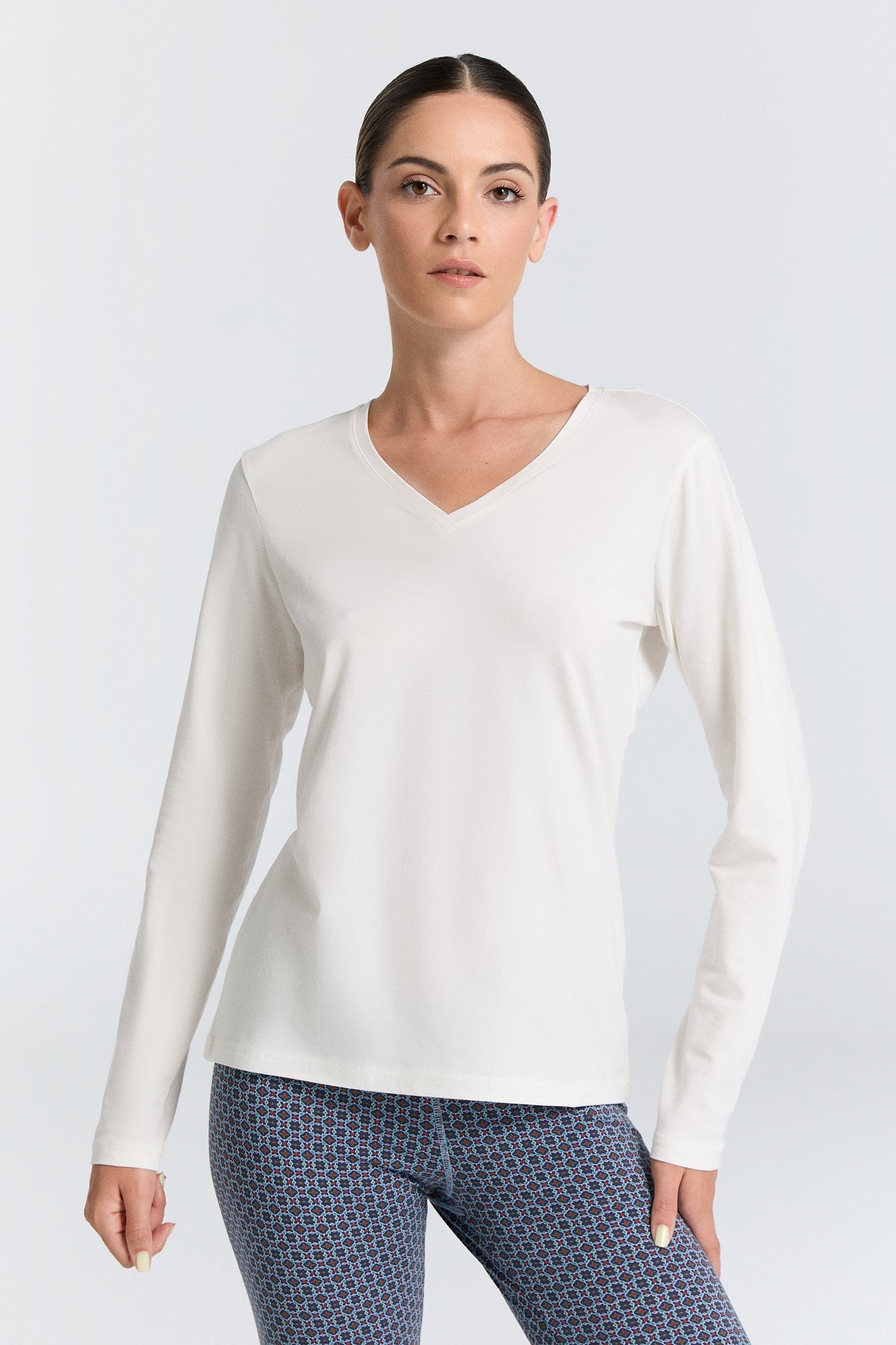 Elegant long sleeve V-neck top made from 95% organic cotton, offering breathability and comfort for all-day wear.