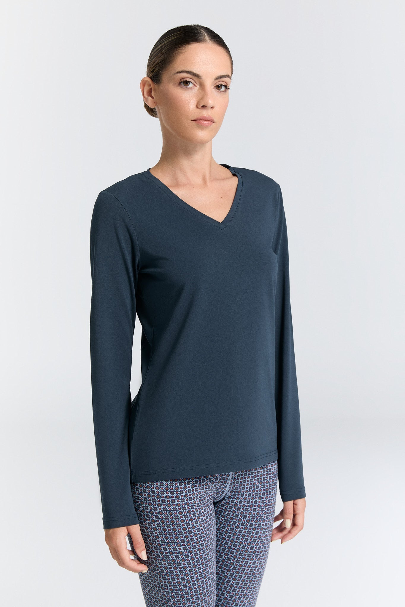 Chic and comfortable body-skimming long sleeve V-neck top, perfect for layering or wearing solo.