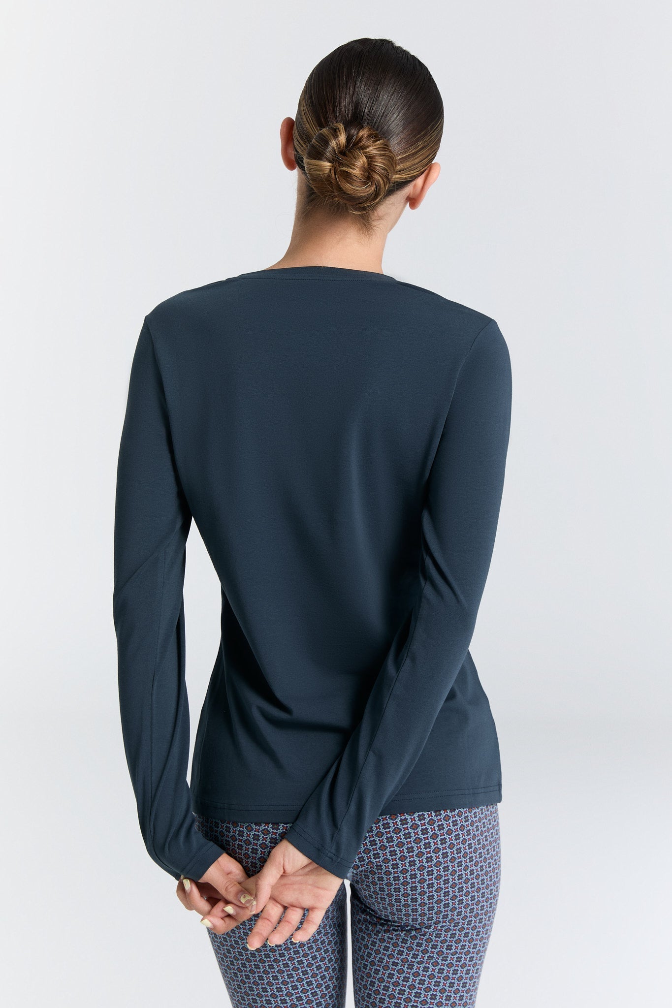 Stylish organic cotton stretch top with long sleeves and a classic V-neckline, designed for sophisticated women's fashion.