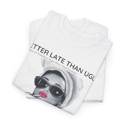 Elegantly folded white graphic tee featuring the empowering slogan 'Better Late Than Ugly' with a vintage-inspired illustration of a confident woman in oversized sunglasses and a luxurious turban-style head wrap.