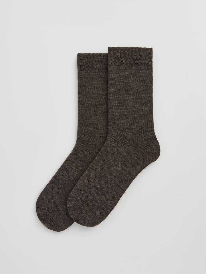 Elegant presentation of odour-resistant calf-length socks made from premium Merino wool, designed for luxury and durability.