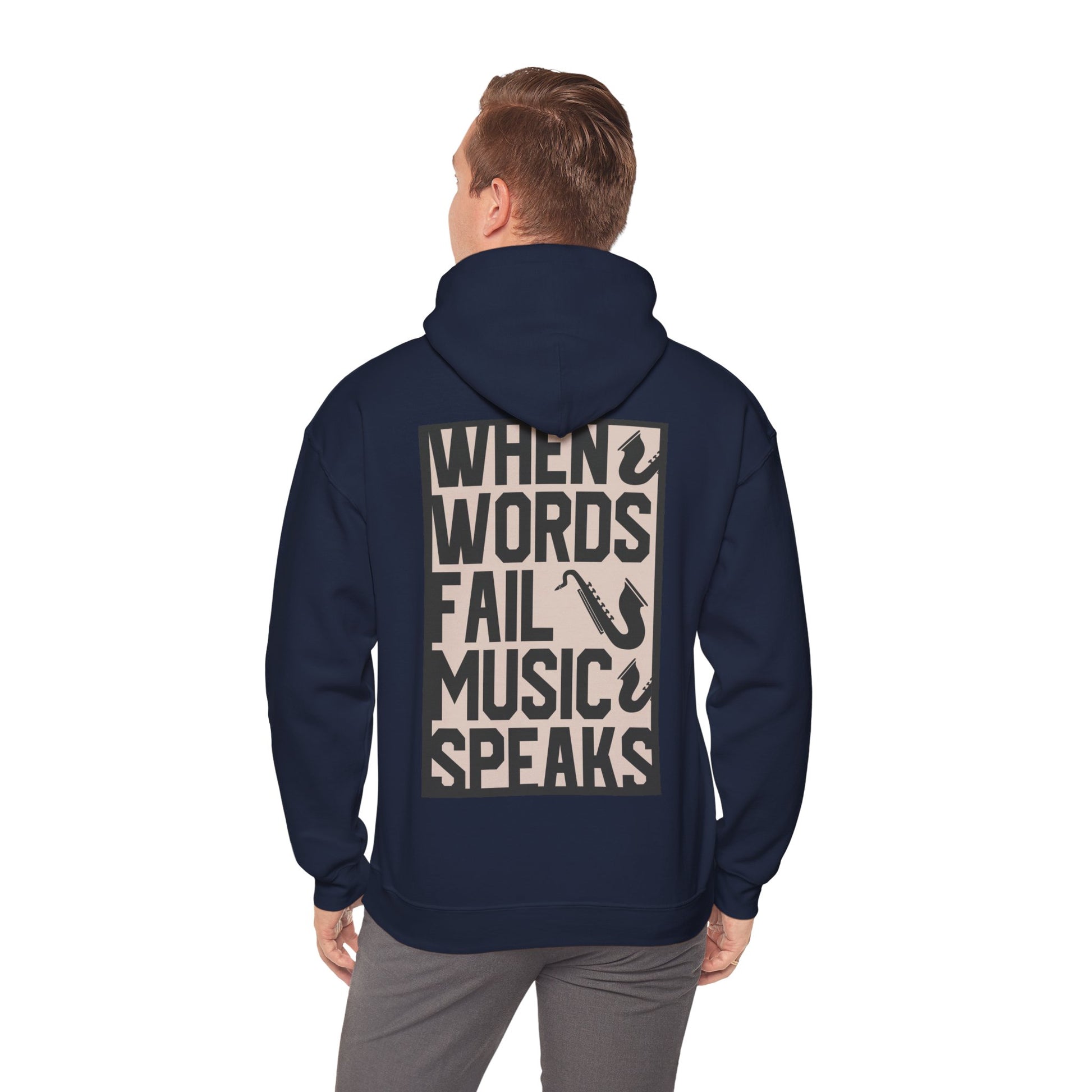 Model showcasing a chic navy hoodie, conveying a stylish vibe with the powerful phrase 'WHEN WORDS FAIL MUSIC SPEAKS' and saxophone designs on the back.