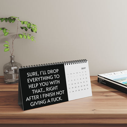 2025 Humorous Desktop Calendar displaying a witty phrase: 'Sure, I’ll drop everything to help you with that... right after I finish not giving a fuck.' Ideal for a sophisticated workspace.