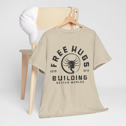 Chic beige t-shirt with a grunge-style 'Free Hugs' logo, elegantly draped over a simplistic wooden chair paired with a white cap.