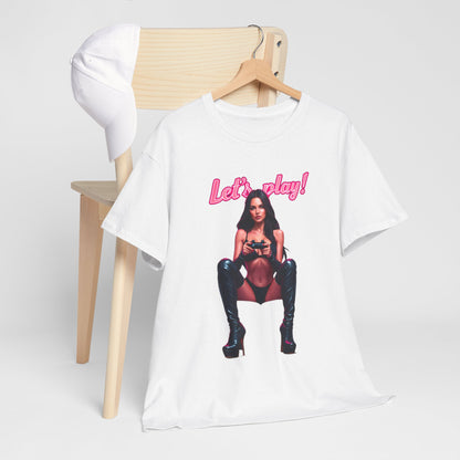 Trendy white graphic t-shirt displayed artistically alongside a stylish cap, featuring a striking 'Let's play!' design, perfect for fashionable gamers.