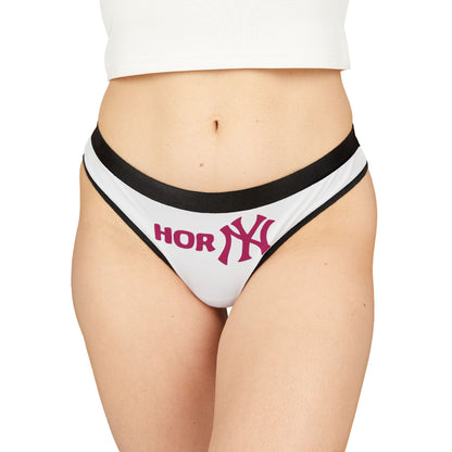 Chic model wearing exquisite thong panties with playful 'Horny' graphics, embodying a blend of comfort and style perfect for confident women.