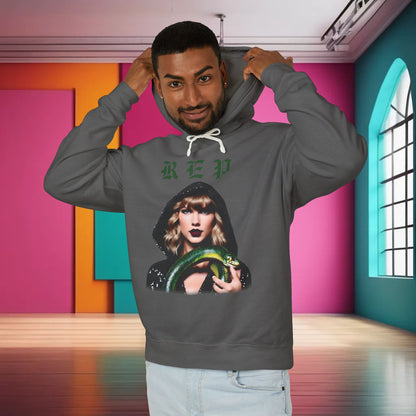 Unisex cotton hoodie for Swifties in luxurious grey, featuring a bold illustration of Taylor Swift holding a green snake, perfect for showcasing your fandom.