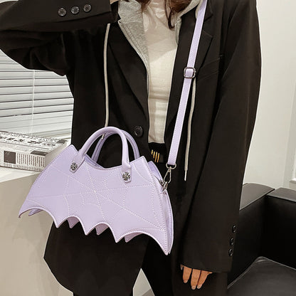Chic lavender Halloween Spider Web Shape Shoulder Bag displayed by model in a stylish black outfit, showcasing its luxurious design inspired by Batgirl aesthetics.