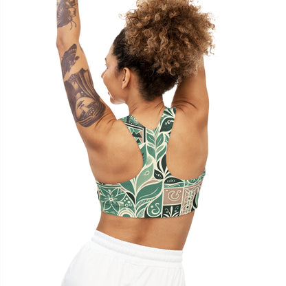 Side view of a model in the Thea Sinclair Pastel Green Sports Bra with modern block print, highlighting its elegant design and exceptional fit as she stretches.