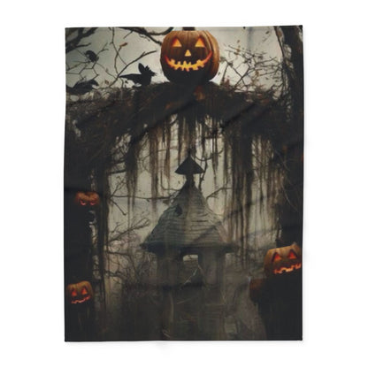 Decorative and Warm Halloween Spooky Arctic Fleece Blanket showcasing a spooky landscape adorned with glowing jack-o'-lanterns and an eerie house silhouette, ideal for Halloween celebrations.