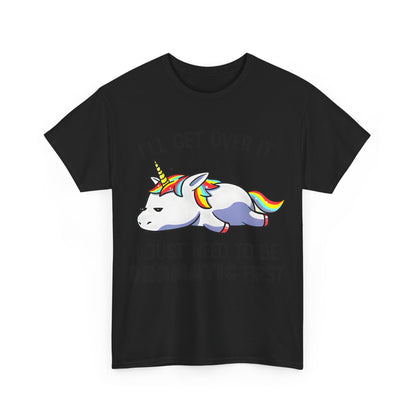Unicorn Melancholy Graphic Tee featuring a cartoon unicorn with a whimsical design that displays the slogan 'I’LL GET OVER IT' and 'I JUST NEED TO BE DRAMATIC FIRST'.
